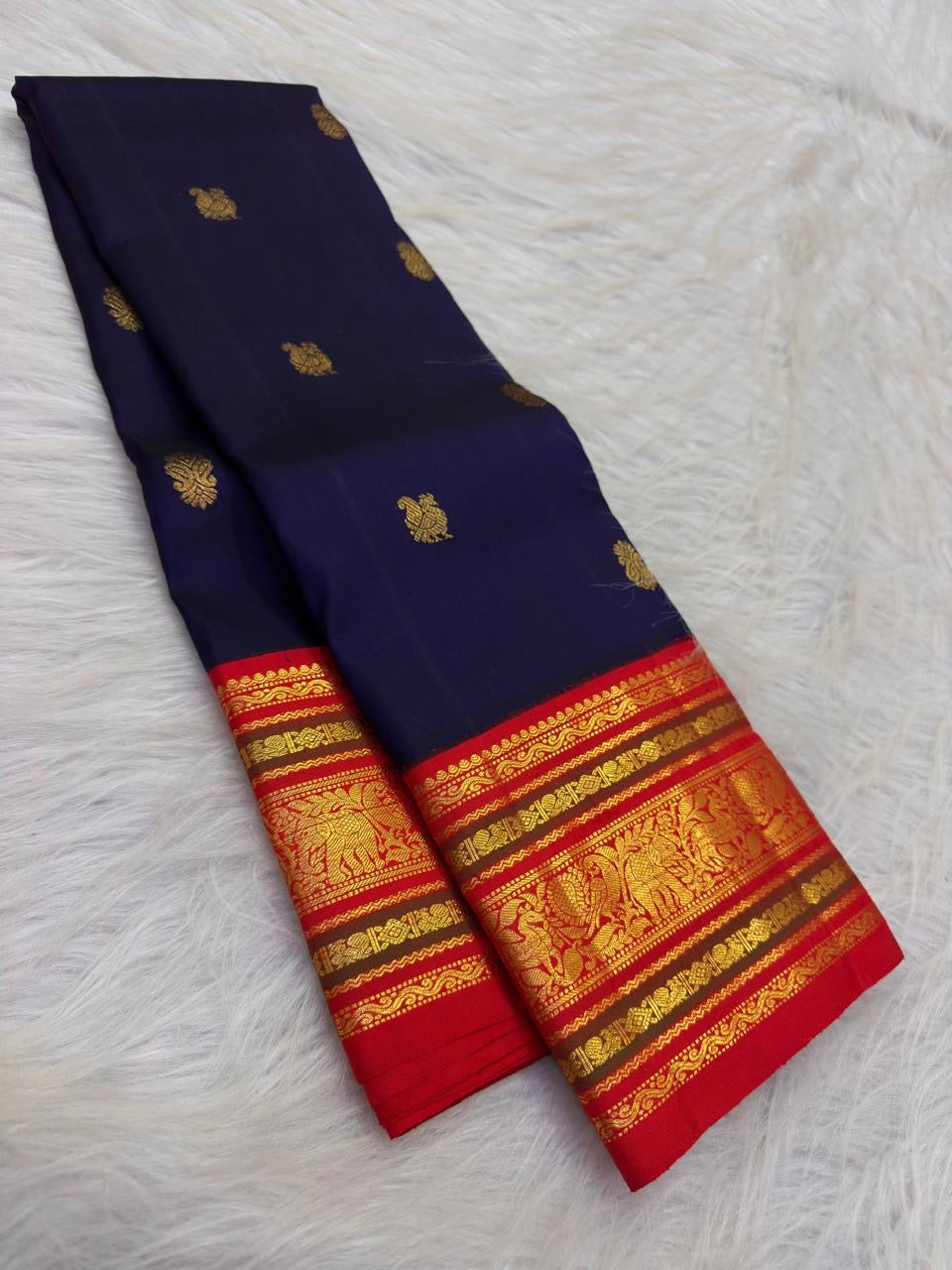 Ink Navy Blue pure silk Kanjivaram Varisaipet saree with Vermilion Red and antique-gold zari border.