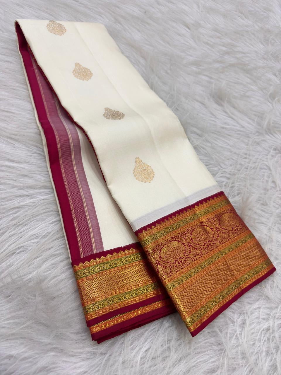 Mughal-inspired floral butta in gold-tone zari woven on pale ivory Kanchipuram silk