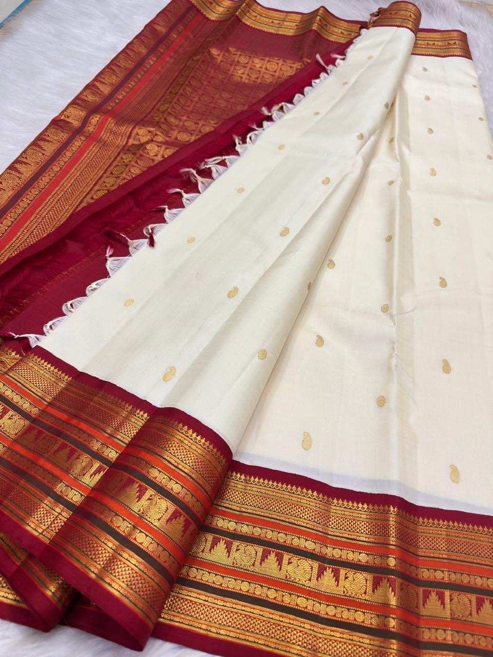 Close view of Kalam paisley buttas on the ivory silk body of a Kanchipuram saree