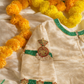 Cream silk velvet blouse flatlay showing choker neckline beadwork and coordinated sleeve medallions
