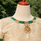 Cream silk velvet blouse sleeves flatlay with kundan medallions, green bead bands, and pearl edging