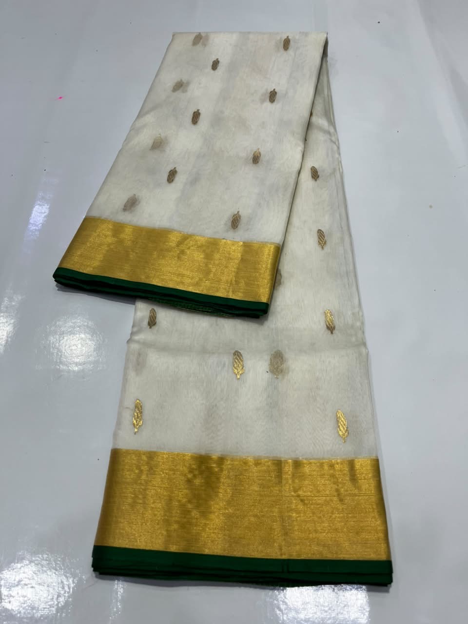Close-up of small gold-tone woven motifs scattered across the Ivory Katan Silk Chanderi saree body.