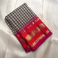 Transition from the ivory checked body into the raspberry-red gold zari border.