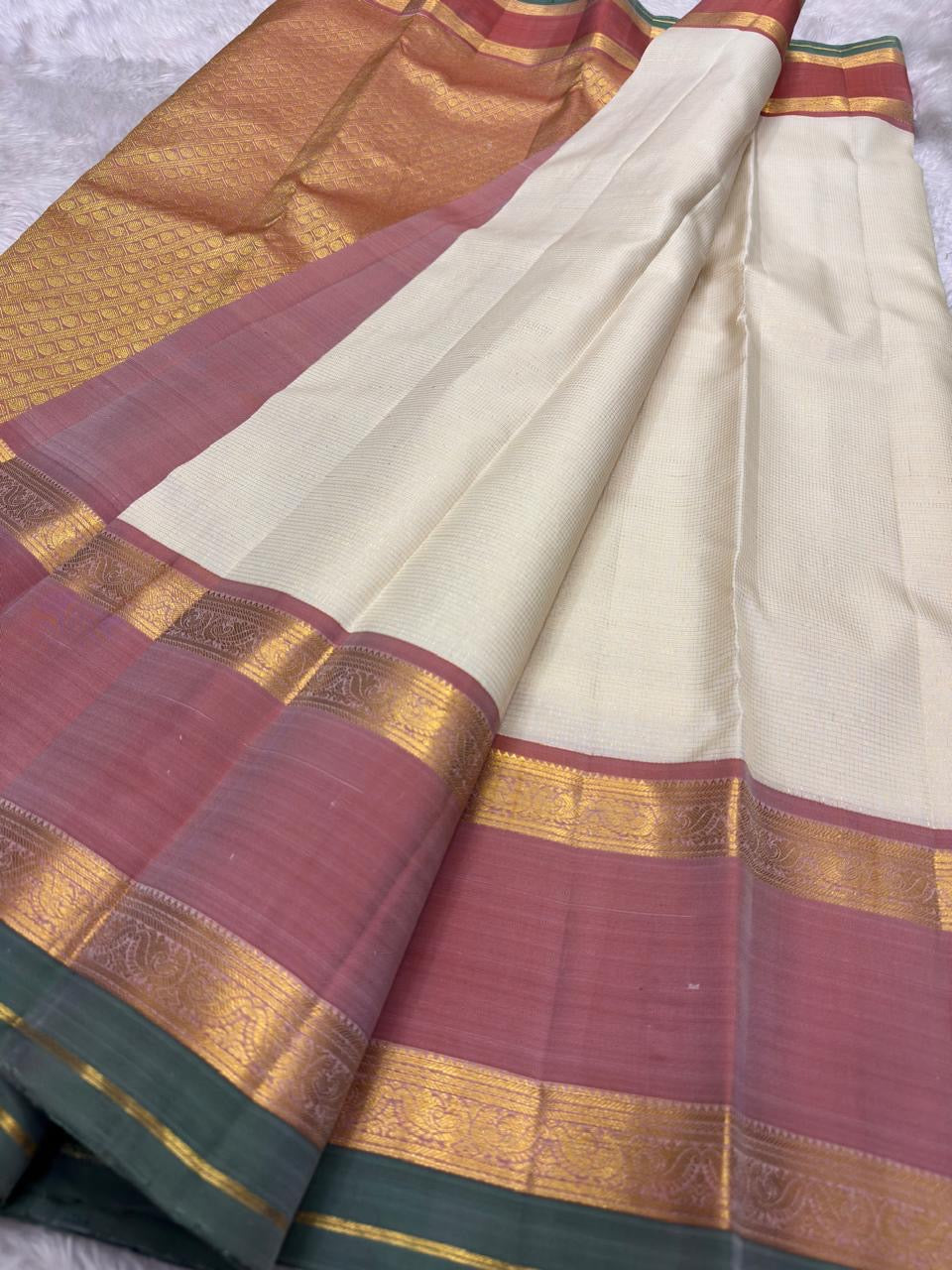 Kanchipattu silk saree in ivory cream with dusty rose border Korvai Rettapet weave traditional zari detail