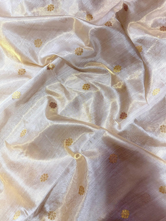 Close view of translucent ivory Chanderi silk surface with fine antique gold zari accents