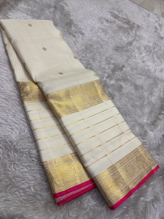 Handwoven Varisaipet saree with antique-gold peacock border and Rani Pink selvedge.