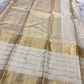Close view of ivory Kanchipuram silk saree pallu with gold zari weaving, subtle grid texture, and lime green edge