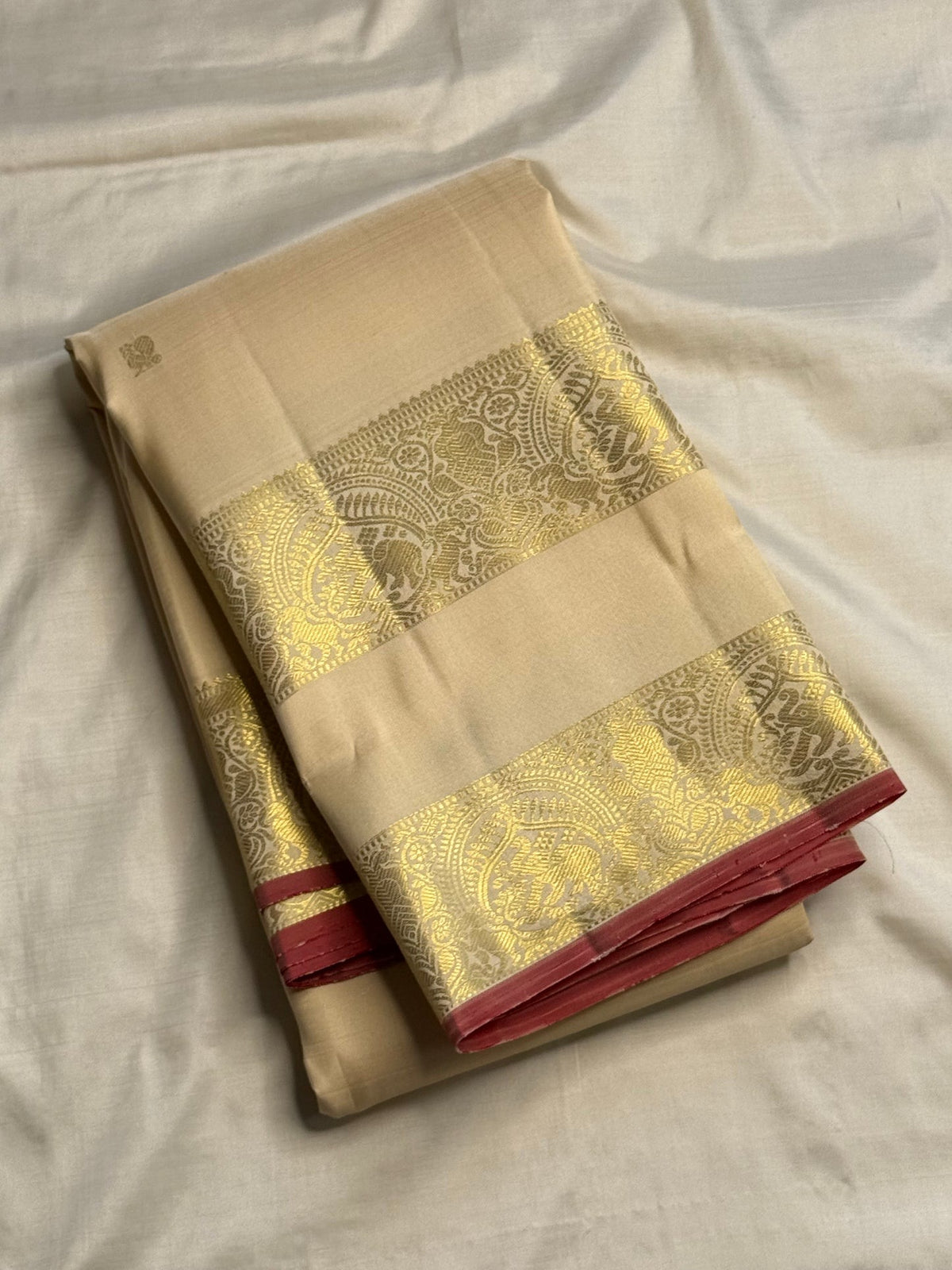Tiny gold-zari buttas across Soft Ivory silk.