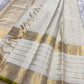 Ivory Kanchipuram silk saree draped to reveal zari kattam checks, antique gold buttas, broad zari border, and tasselled pallu