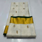 Ivory Katan Silk Chanderi saree showing the gold-tone border finished with a slender Deep Emerald Green edge.