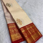 Handwoven ivory Korvai Kanchipuram silk saree with classic red and gold contrast framing.