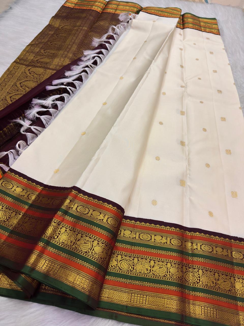 Ivory pure silk Kanchipuram saree with Mayil Chakram buttas and ornate varisaipet border