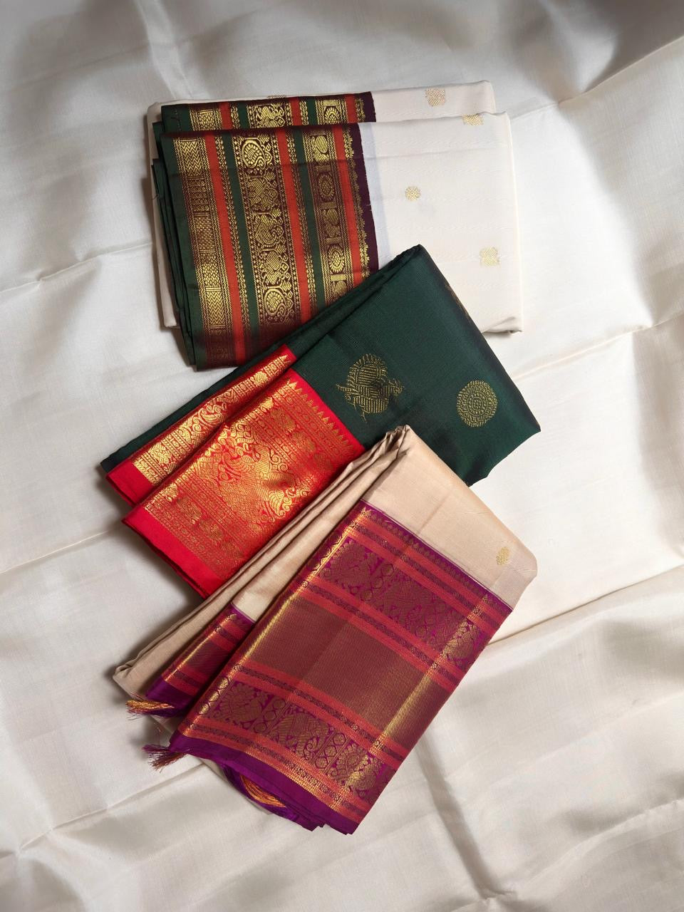 Kanjivaram varisaipet saree in ivory with Mayil Chakram buttas across the body