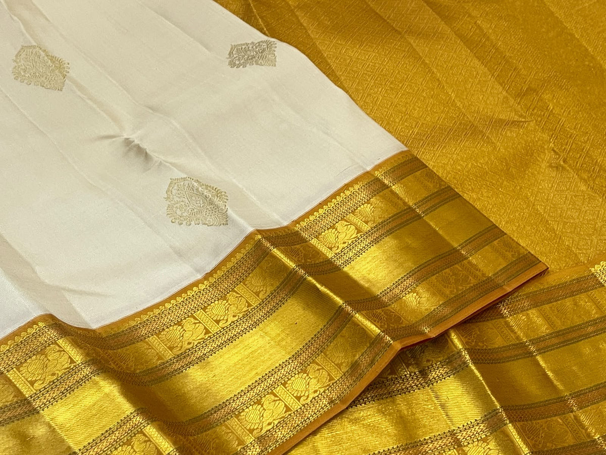 Venpattu Ivory Pure Silk Kanchipuram Butta Saree with Manjal Gold Pettu