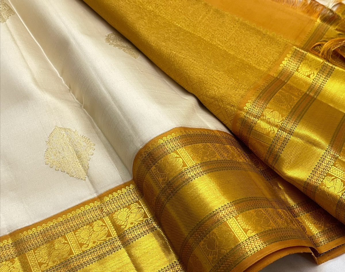 Venpattu Ivory Pure Silk Kanchipuram Butta Saree with Manjal Gold Pettu