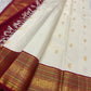 Ivory Pure Silk Kanchipuram Varisaipet saree with petite gold maanga buttas and an Arakku red border.