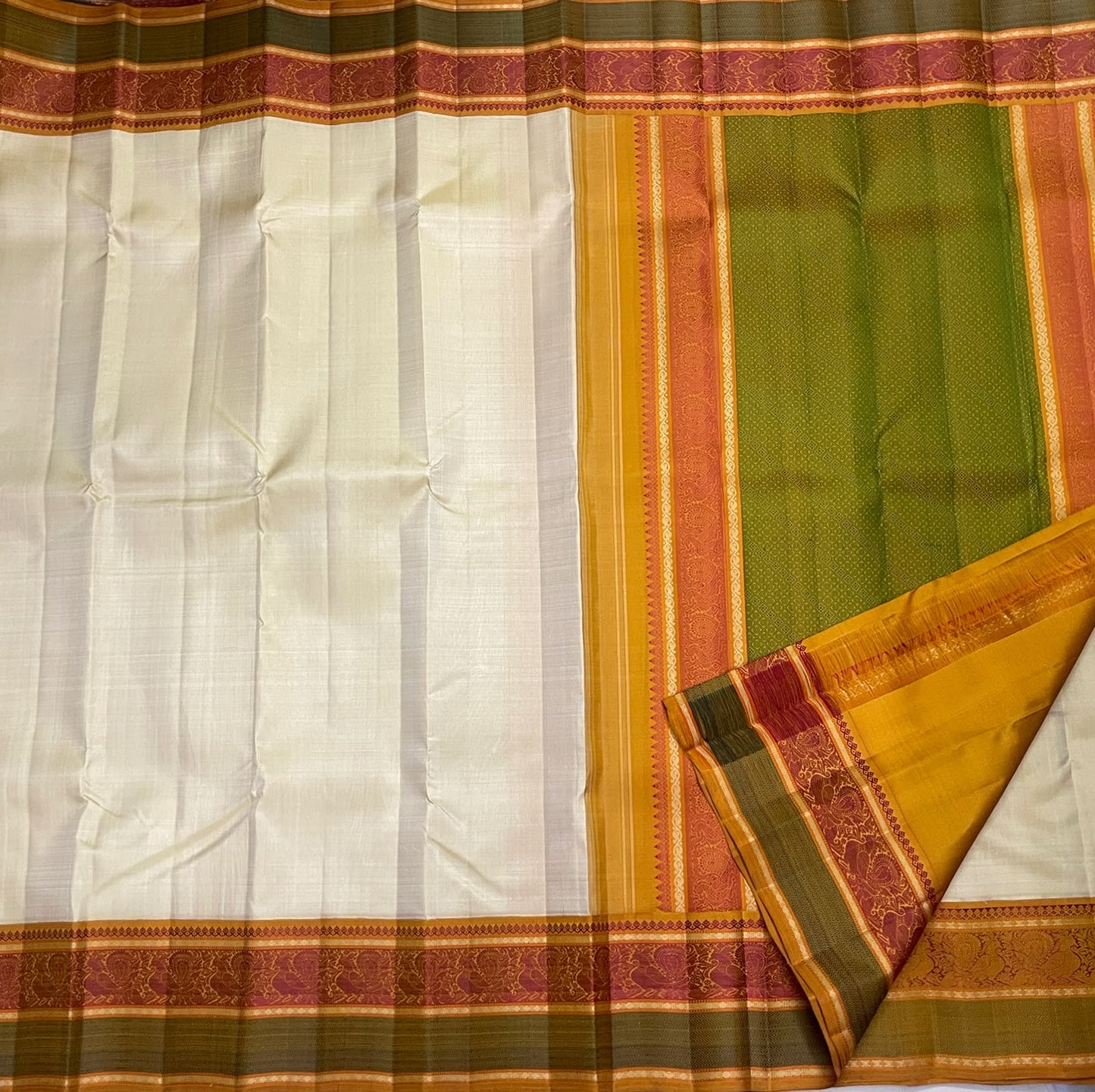 Ivory Kanchipuram Pattupet saree with no-zari border, draped view