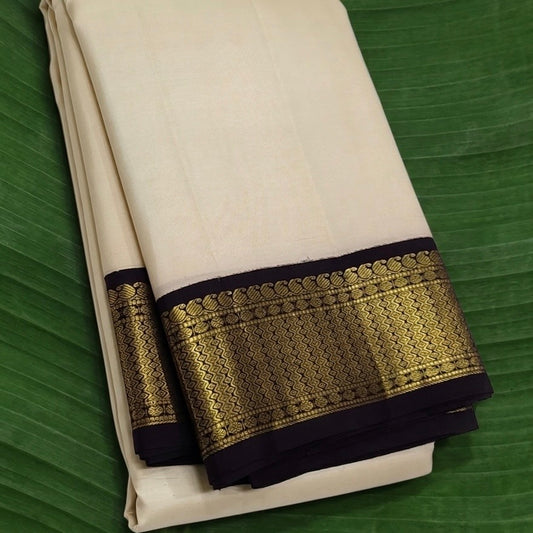 Kanchipuram silk saree in muted vanila white with intricate black gold border Korvai weave folded view