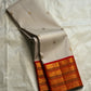 Ivory Pure Kanchipuram Silk Saree drape showing scattered gold buttas and zari border with red edge