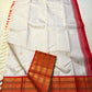 Pure Kanchipuram Silk Saree laid flat with ivory body, gold buttas, zari border, red side border, and tassels