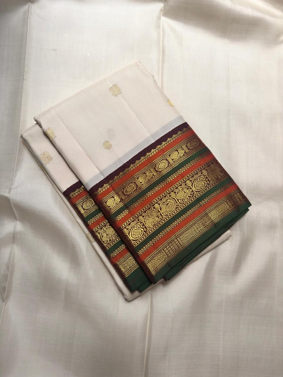 Ivory Kanchipuram silk saree with detailed ornate border bands in zari and silk thread