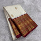 Ivory handwoven Kanchipuram Varisaipet silk saree with Arakku red border and gold zari.