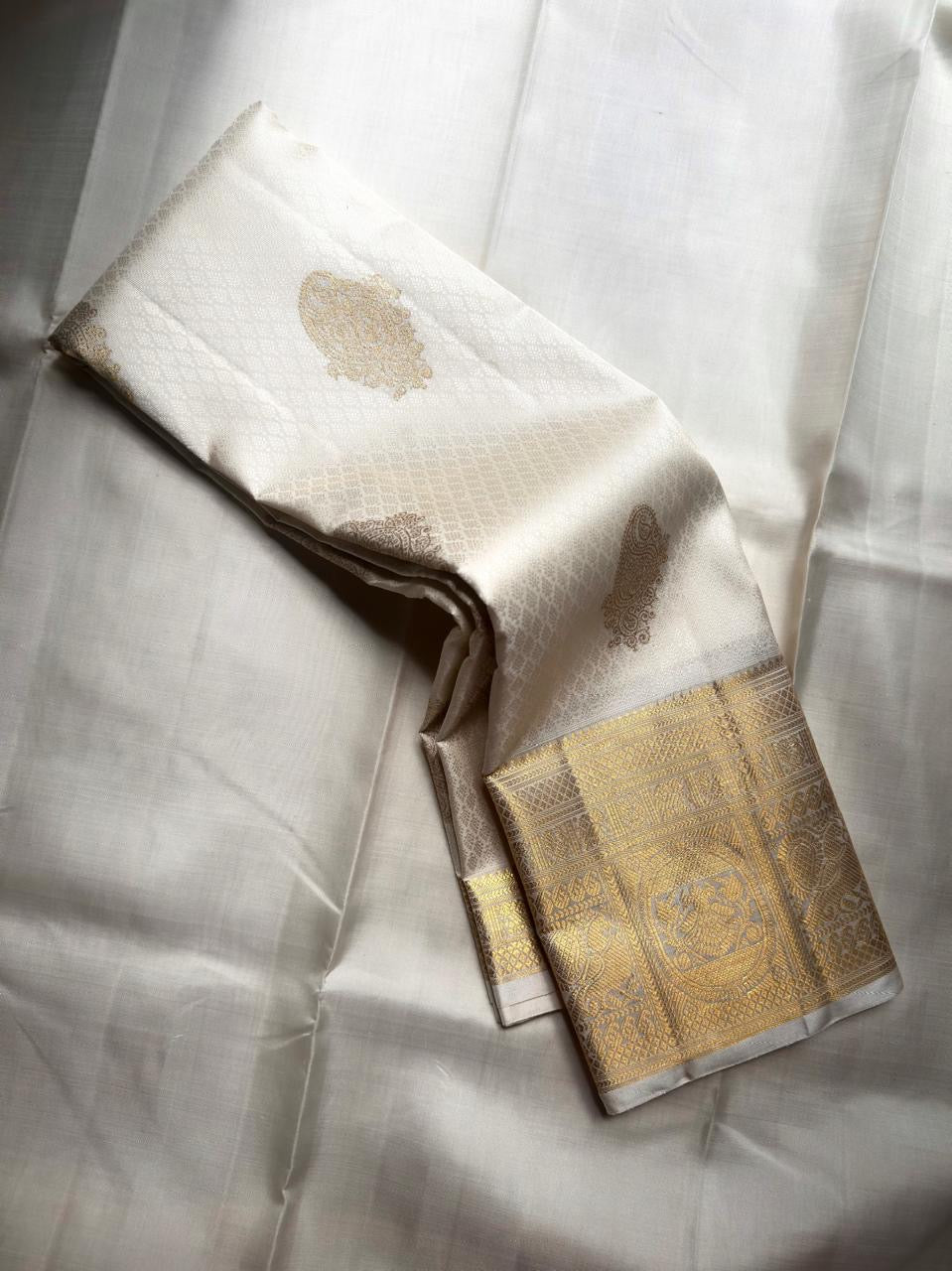 Ivory Handwoven Pure Silk Kanjivaram Saree with Gold Zari Buttas and Ornate Border – front full drape view