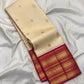 Close view of petite gold zari buttas on warm buttercream ivory Kanchipuram silk