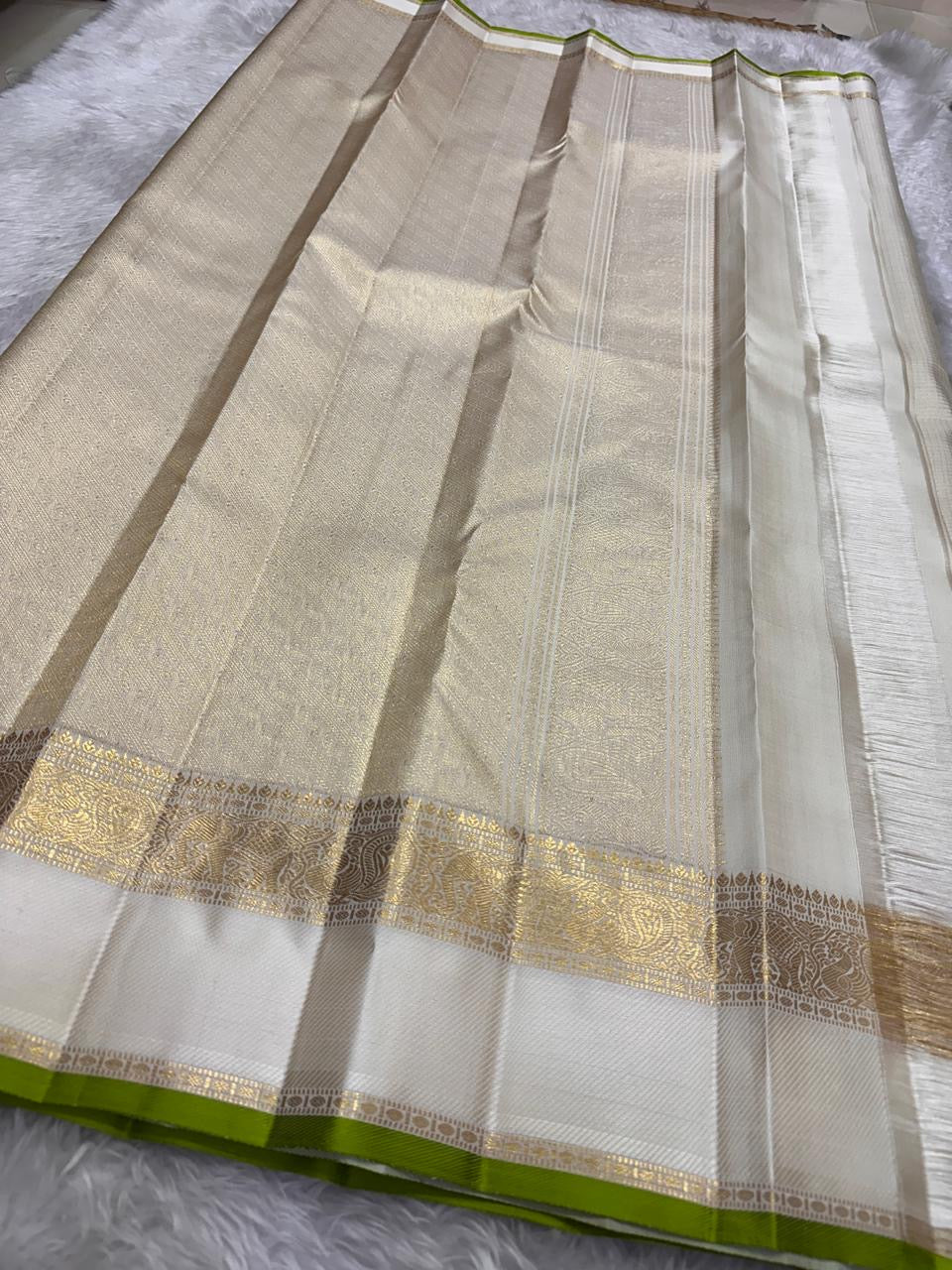 Traditional ivory Kanchipuram saree with gold zari and temple-inspired border