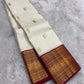 Ivory Kanjivaram silk with a deep Arakku red Varisaipet border in layered zari registers.