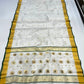 Full view of Ivory Katan Silk Chanderi saree with scattered gold motifs and pallu featuring larger gold motifs with green centres.