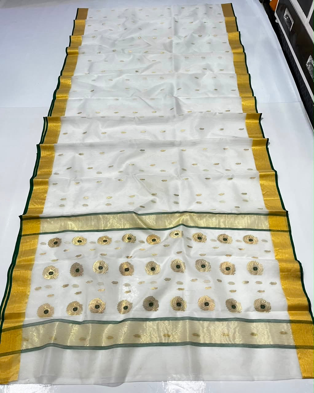 Full view of Ivory Katan Silk Chanderi saree with scattered gold motifs and pallu featuring larger gold motifs with green centres.