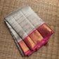 Ivory Kora silk Kancheepuram saree with delicate gold Kattam grid.