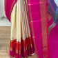 Mannequin drape of ivory Kanchipuram silk saree with hot pink zari woven border and teal-blue pallu band.