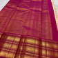 Ivory and magenta pink Kanchipuram silk saree draped to show body and border