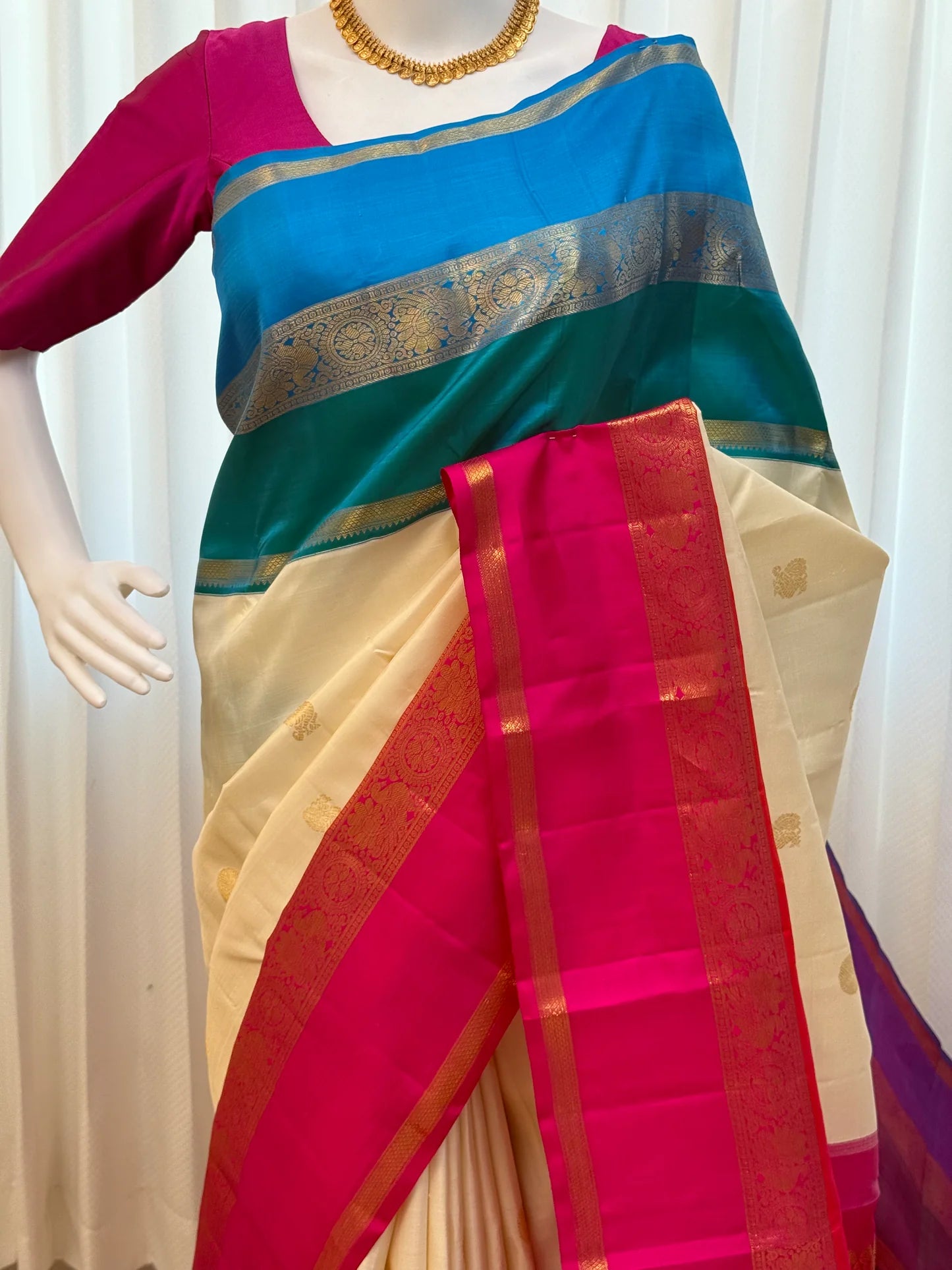 Full drape with hot pink border and teal-blue pallu accents displayed indoors, shipped from New Jersey USA.