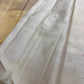 Close view of pale antique-gold geometric zari border on Pearl Ivory Kanchipuram silk.