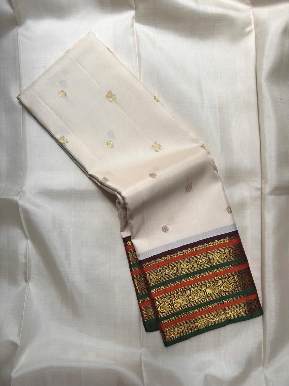 Ivory handwoven pure silk Kanchipuram varisaipet saree with zari and silk thread bands