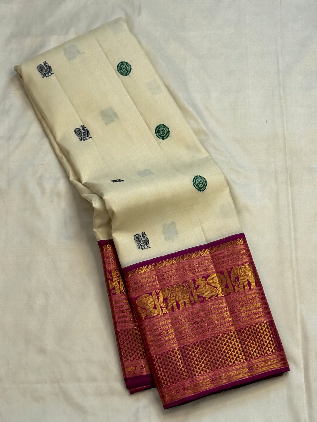 Ivory pure silk Kanjivaram body with Mayil Chakram buttas, close view
