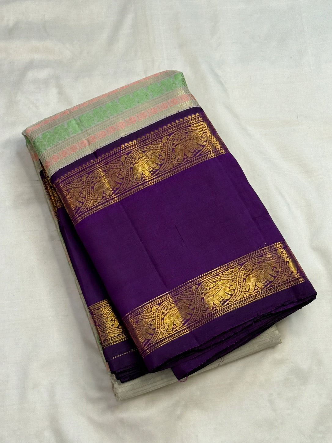 Ivory pastel Veldhari Kanchipuram pure silk saree with royal purple Yaanai Rettapet border
