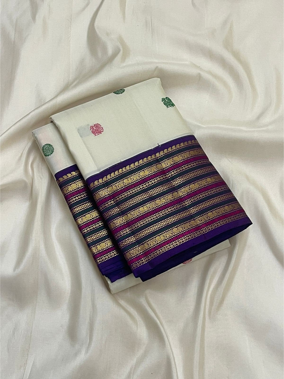 Close view of Raspberry Pink and Deep Green silk thread buttas on ivory silk