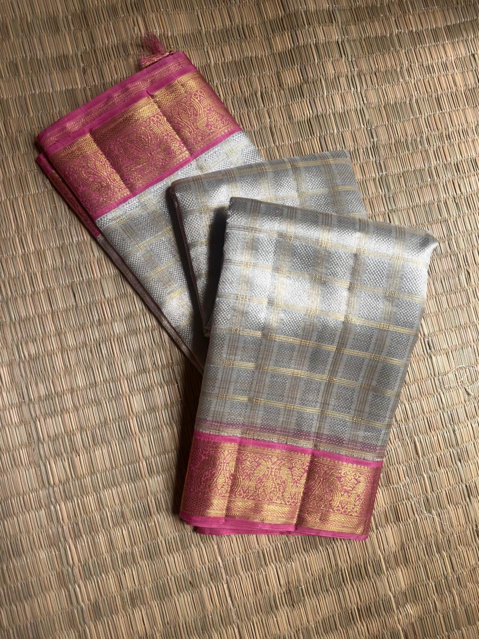 Ivory and Rani Pink Kora Kanjivaram silk Korvai saree.