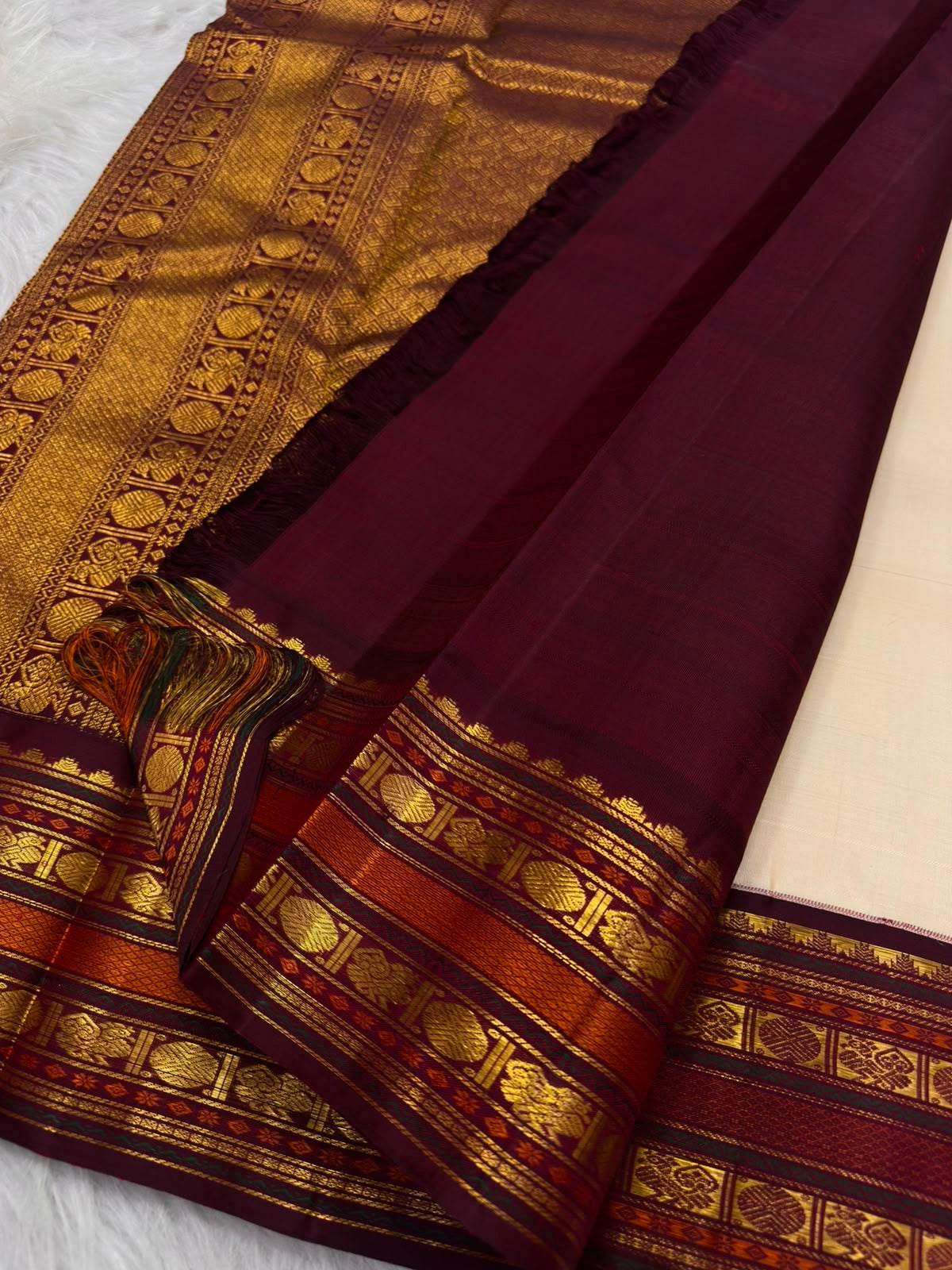 Maanga paisley and Kamalam lotus buttas in gold zari, warm-ivory Kanjivaram saree