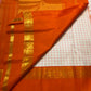Ivory Kanchi Pattu saree body close-up showing fine rust orange check weave