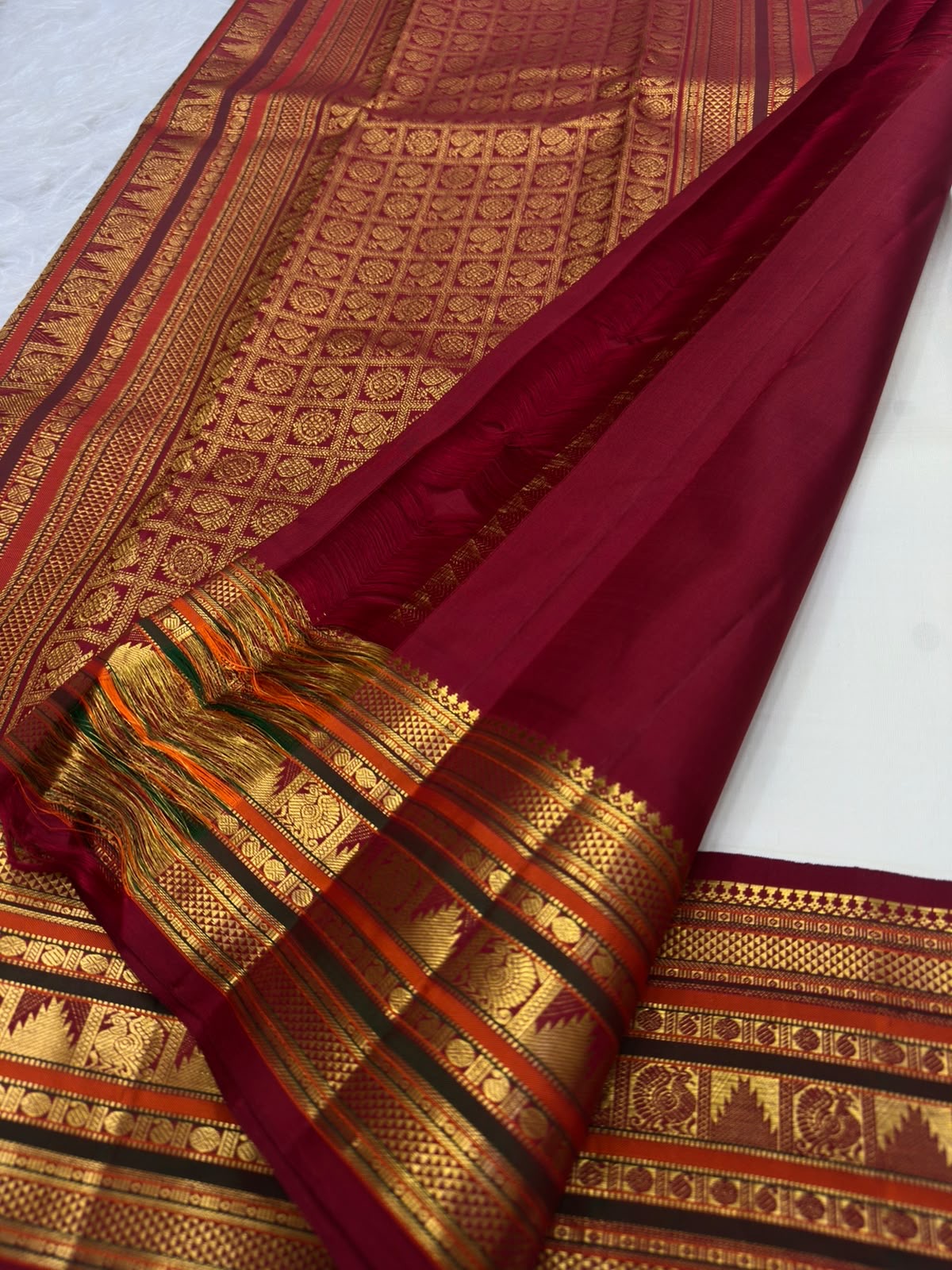 Sevvanthi rust-orange border detail, warm-ivory Kanchipuram Korvai saree