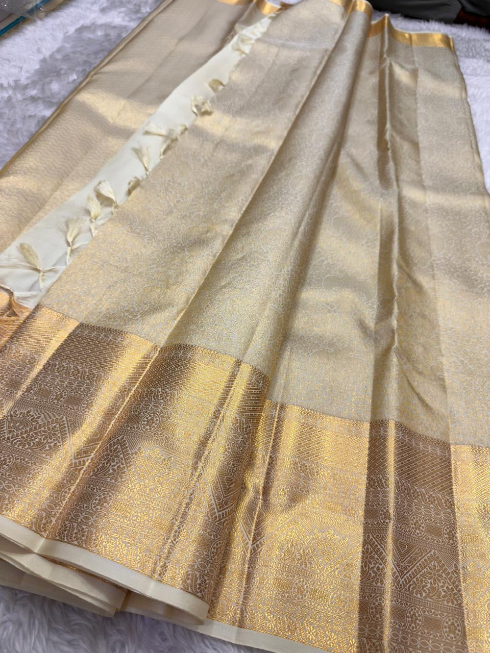 Gold zari border detail on ivory tissue Kancheepuram saree