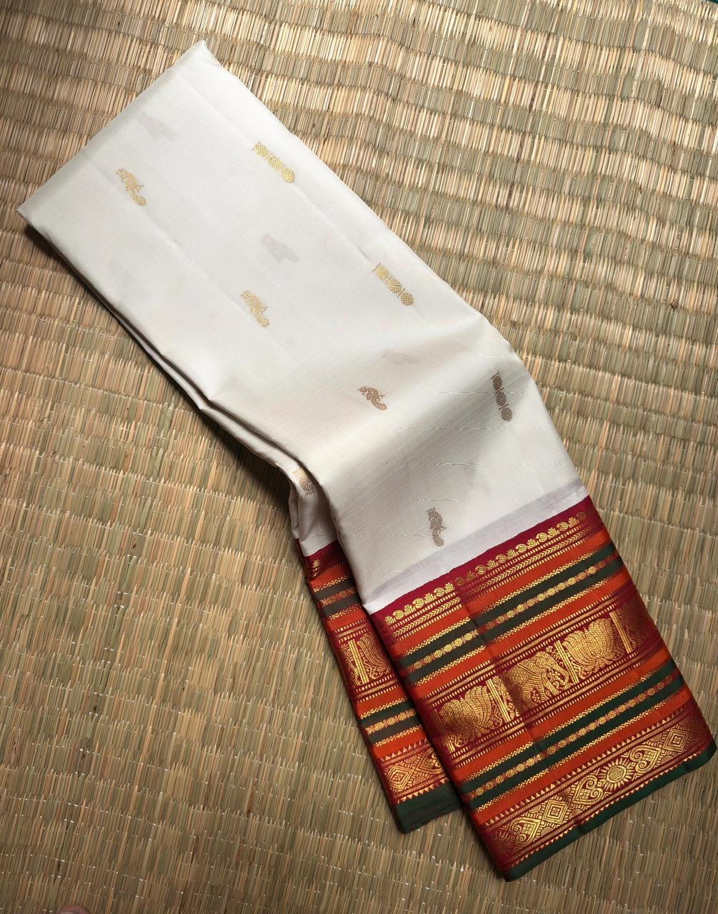 Ivory Kanjivaram silk saree with vermilion red Varisaipet border, close view