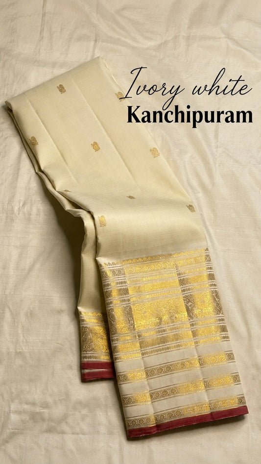Ivory handwoven pure silk Kanchipuram saree full drape with zari buttas and raspberry pink selvedge border