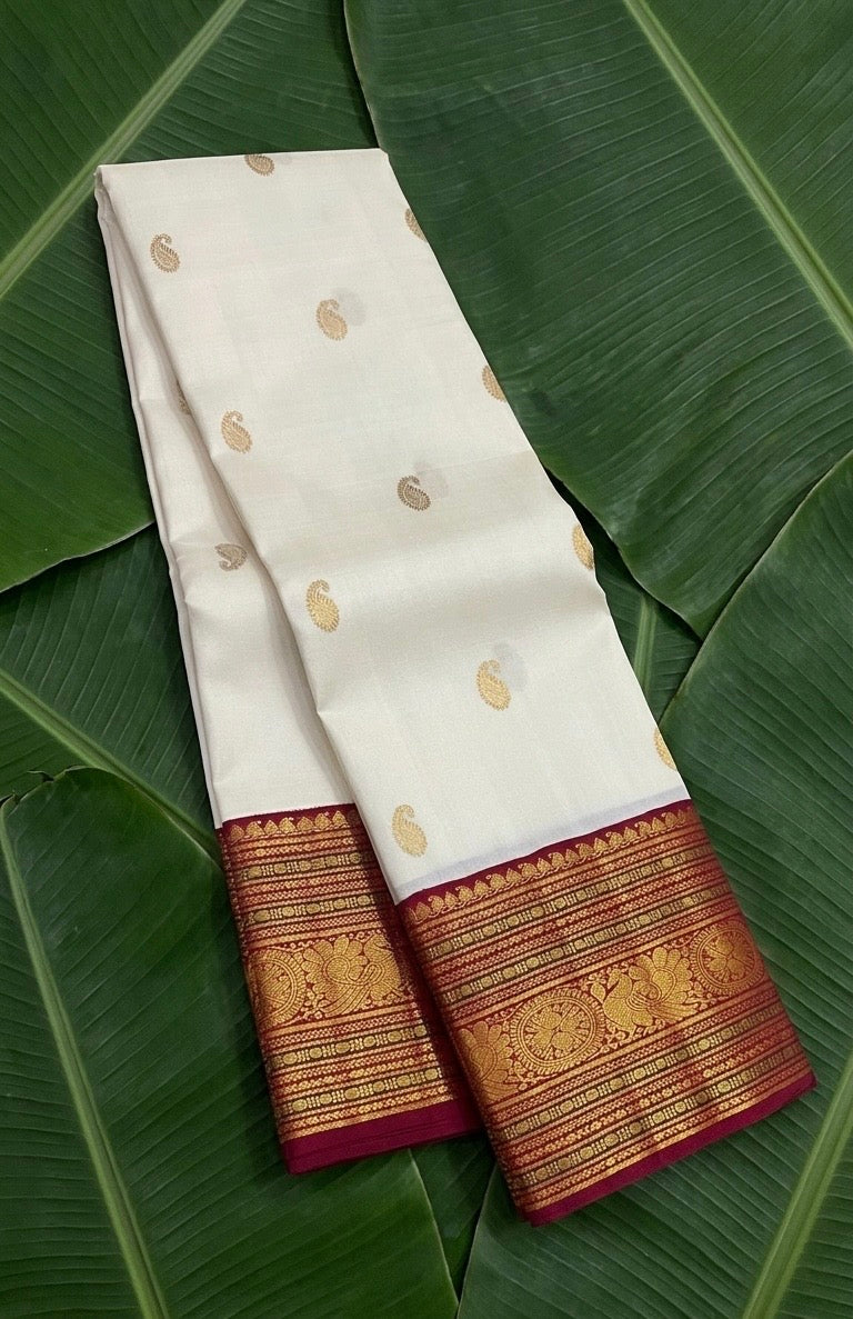 Ivory white handwoven Kanchipuram pure silk saree with maanga butta and maroon korvai border — Idam Living