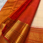 Elaborate Paisley motif pallu in dense gold on deep red Korvai ground of ivory Kancheepuram